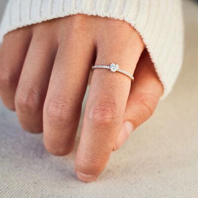 a woman's hand with a diamond ring on it