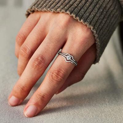 a woman's hand with a diamond ring on it