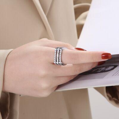 a woman wearing a ring holding a book