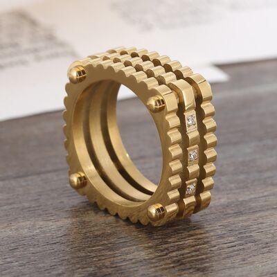 a gold ring sitting on top of a wooden table