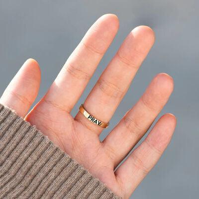 a person's hand with a gold ring on it