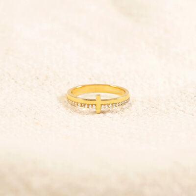 a gold ring with a cross on it