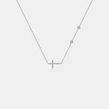 a diamond cross necklace on a white background