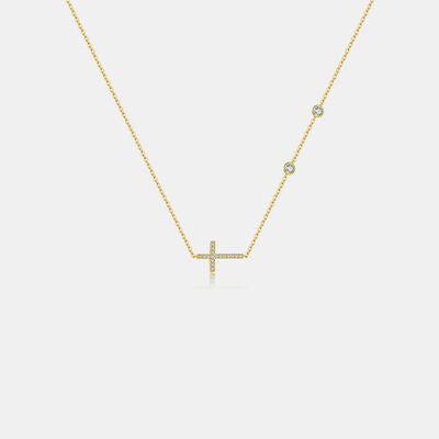 a diamond cross necklace on a white background