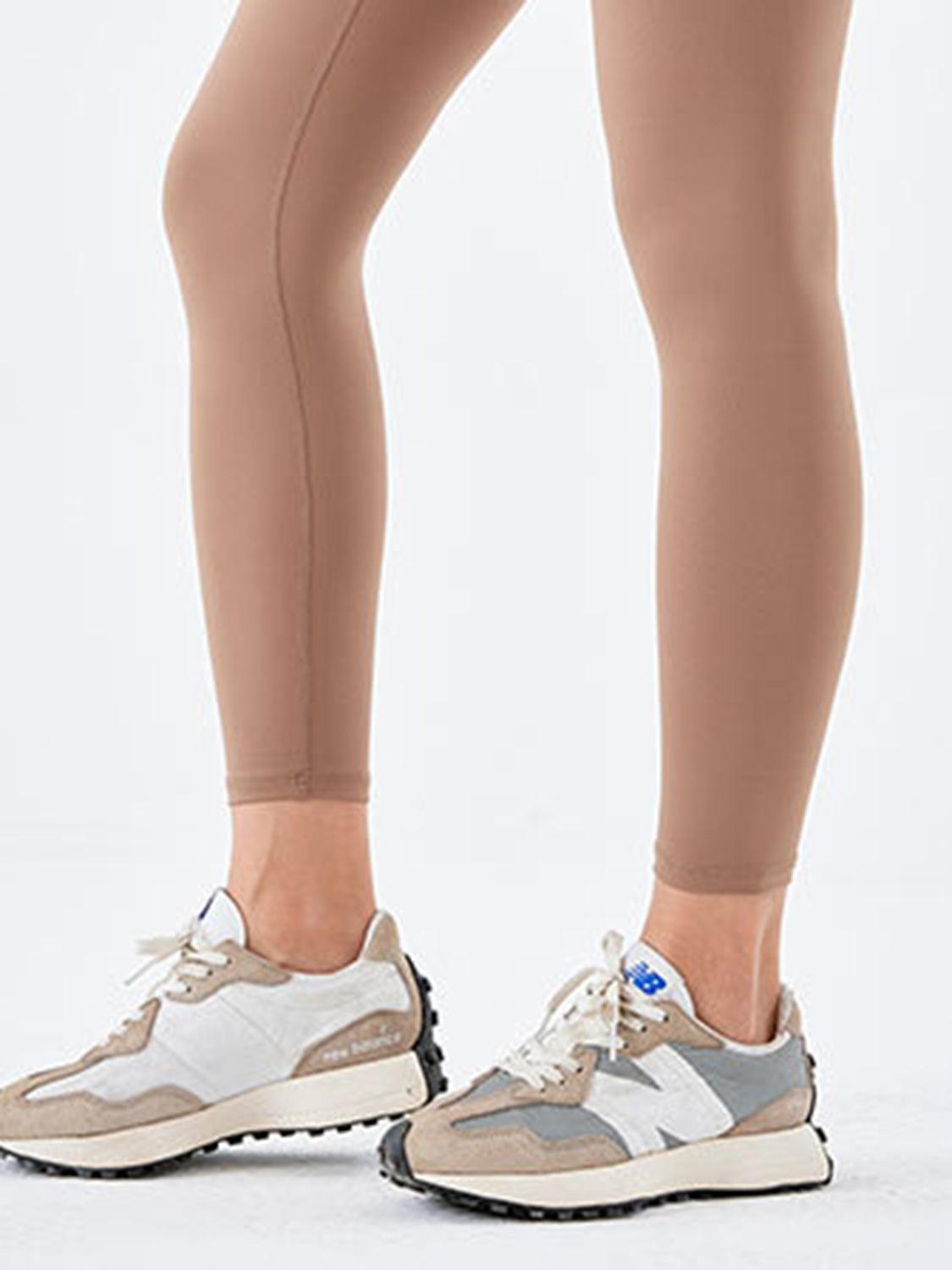 a woman's legs in a pair of beige leggings