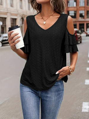 a woman wearing a black cold shoulder top