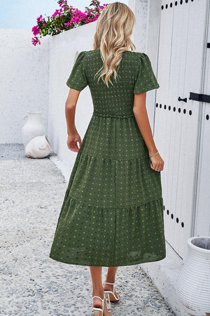 a woman in a green polka dot dress