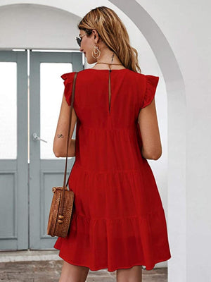 a woman in a red dress is walking towards a door