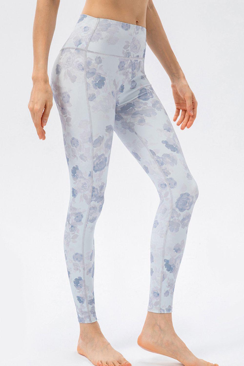 a woman in a white top and blue floral print leggings