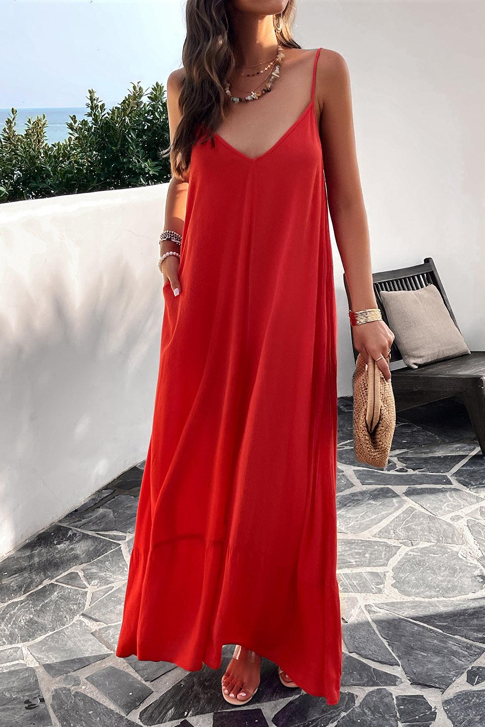 a woman in a red dress standing on a patio