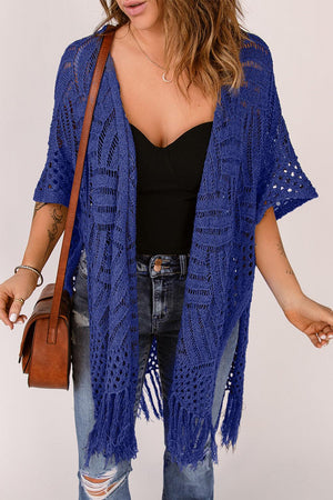 a woman wearing a blue crochet cardigan