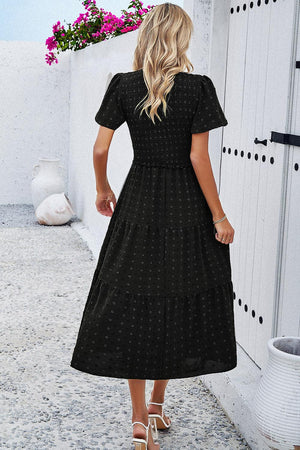 a woman in a black polka dot dress
