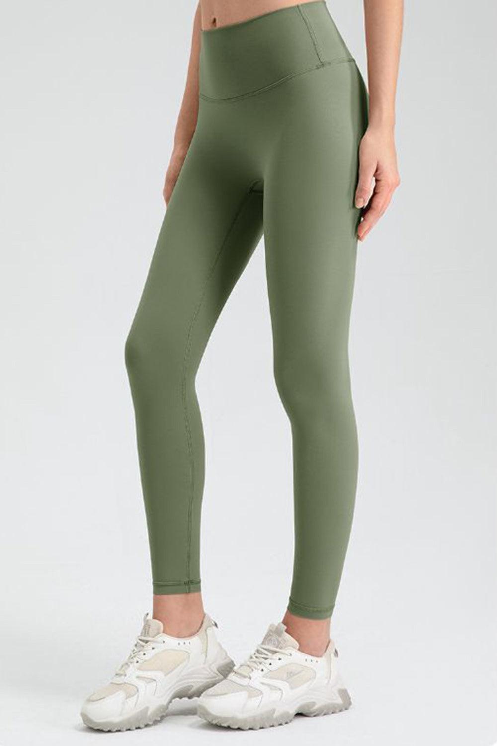 a woman in green leggings with a white top
