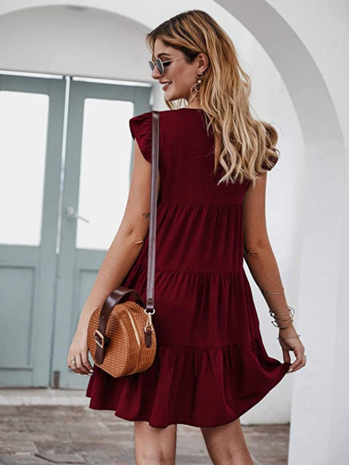 a woman in a red dress is holding a brown purse
