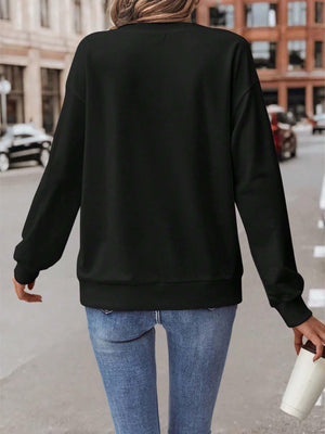 a woman walking down a street holding a cup of coffee