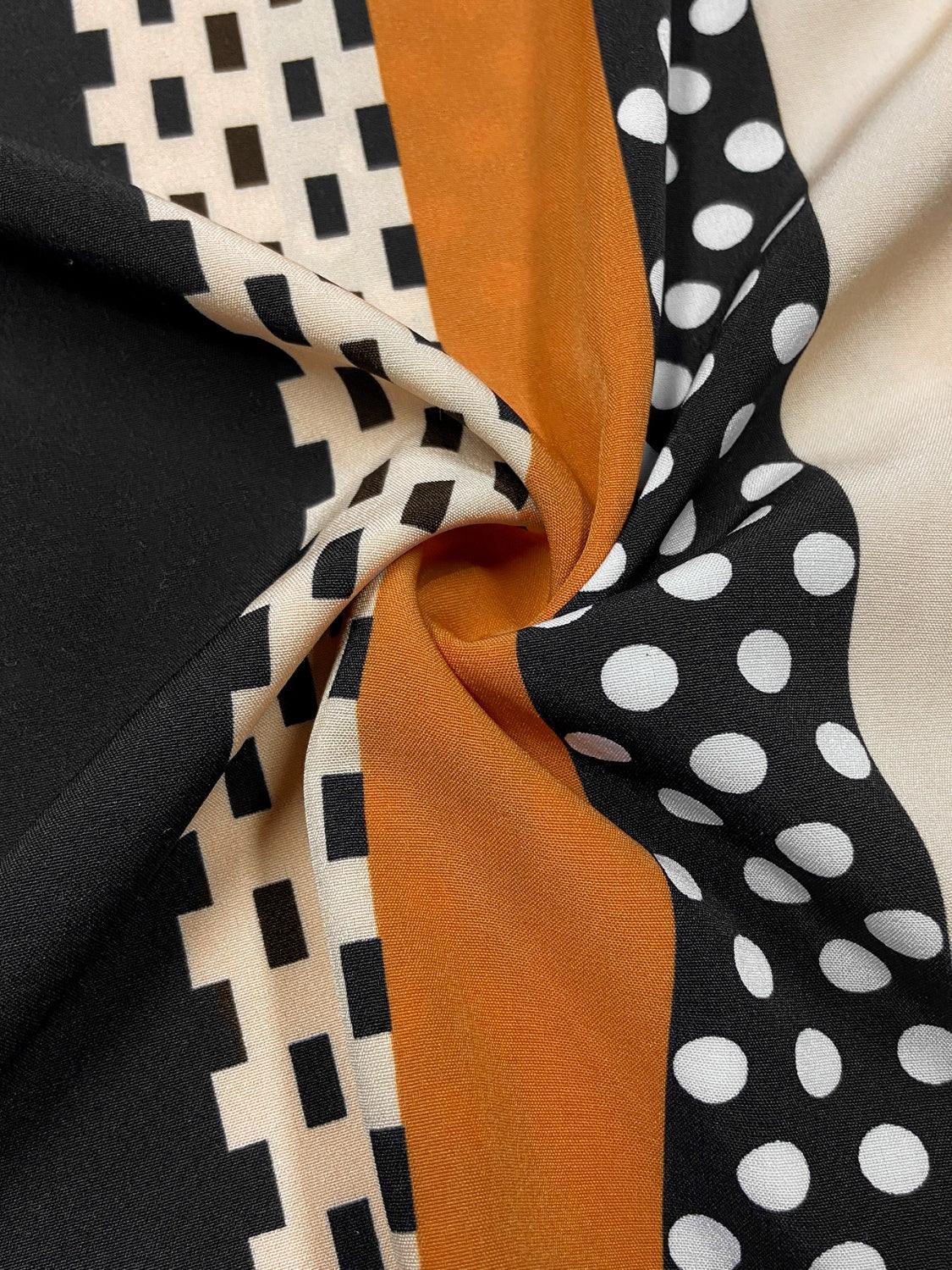 a close up of a black and white polka dot scarf