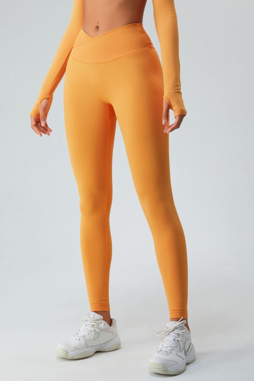 a woman in an orange sports bra top and leggings