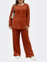 a woman in a brown sweater and pants