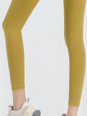 a woman in yellow leggings and sneakers