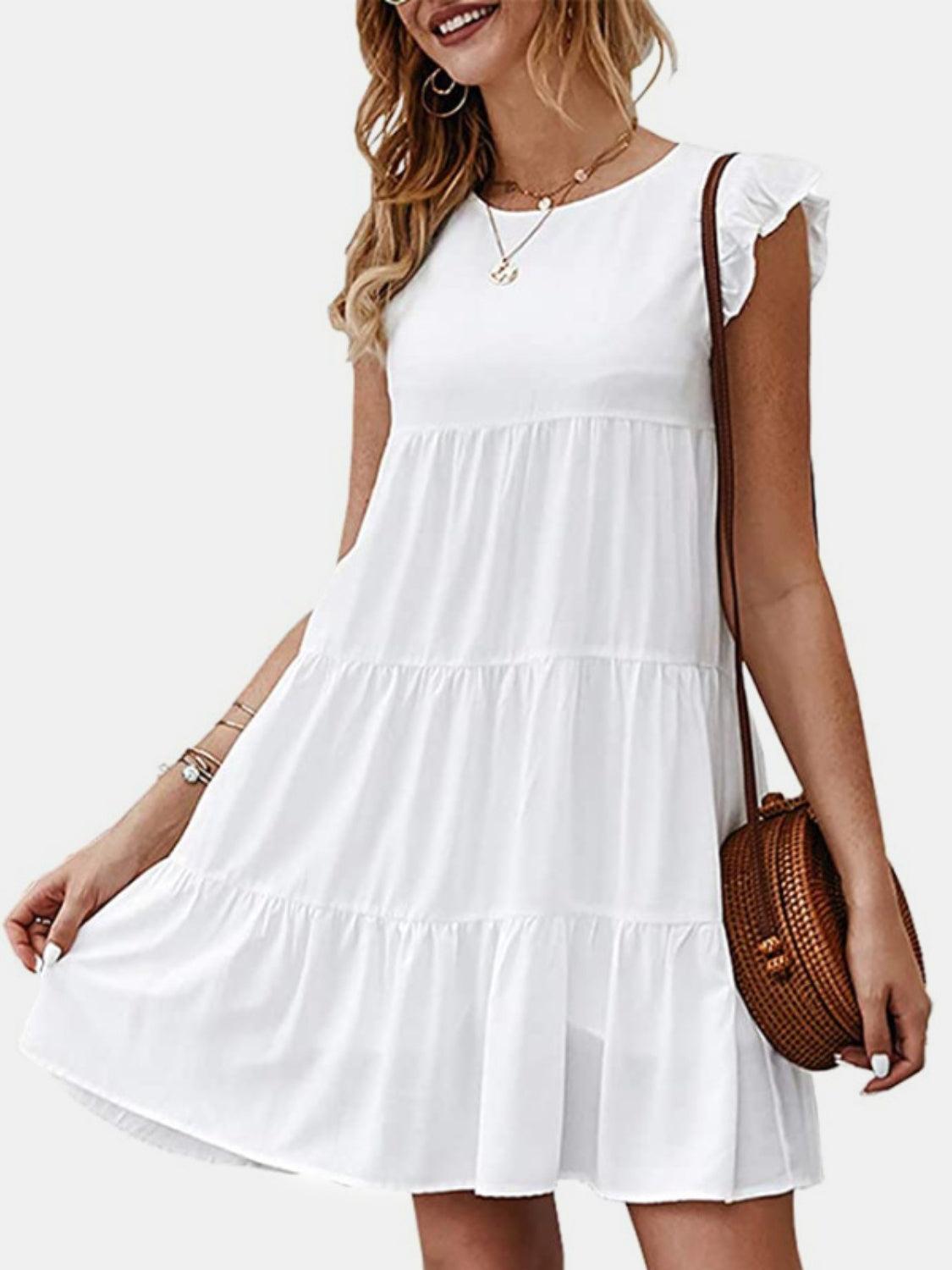 a woman wearing a white dress with a brown purse