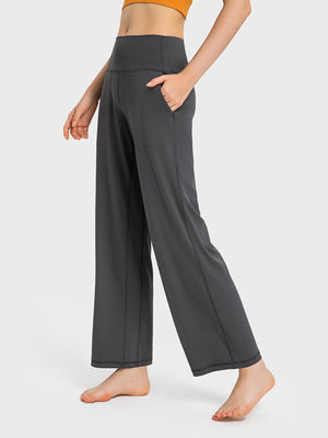 a woman in a crop top and wide legged pants