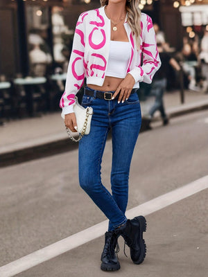 a woman in a pink and white jacket and jeans