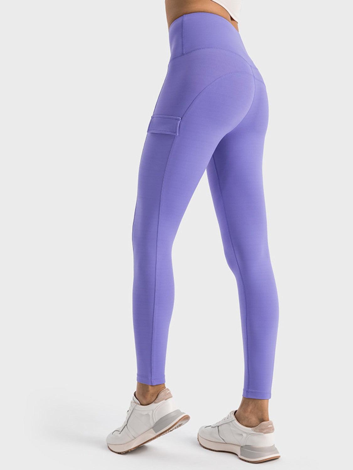 a woman in a white top and purple leggings