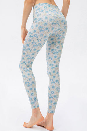 a woman wearing a blue and white floral print leggings