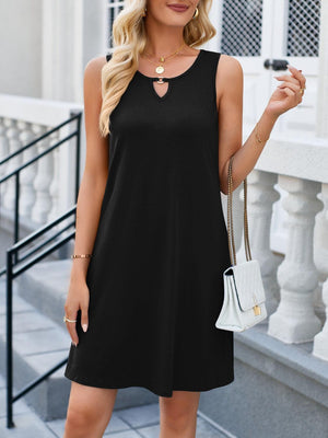a woman wearing a black dress and sunglasses