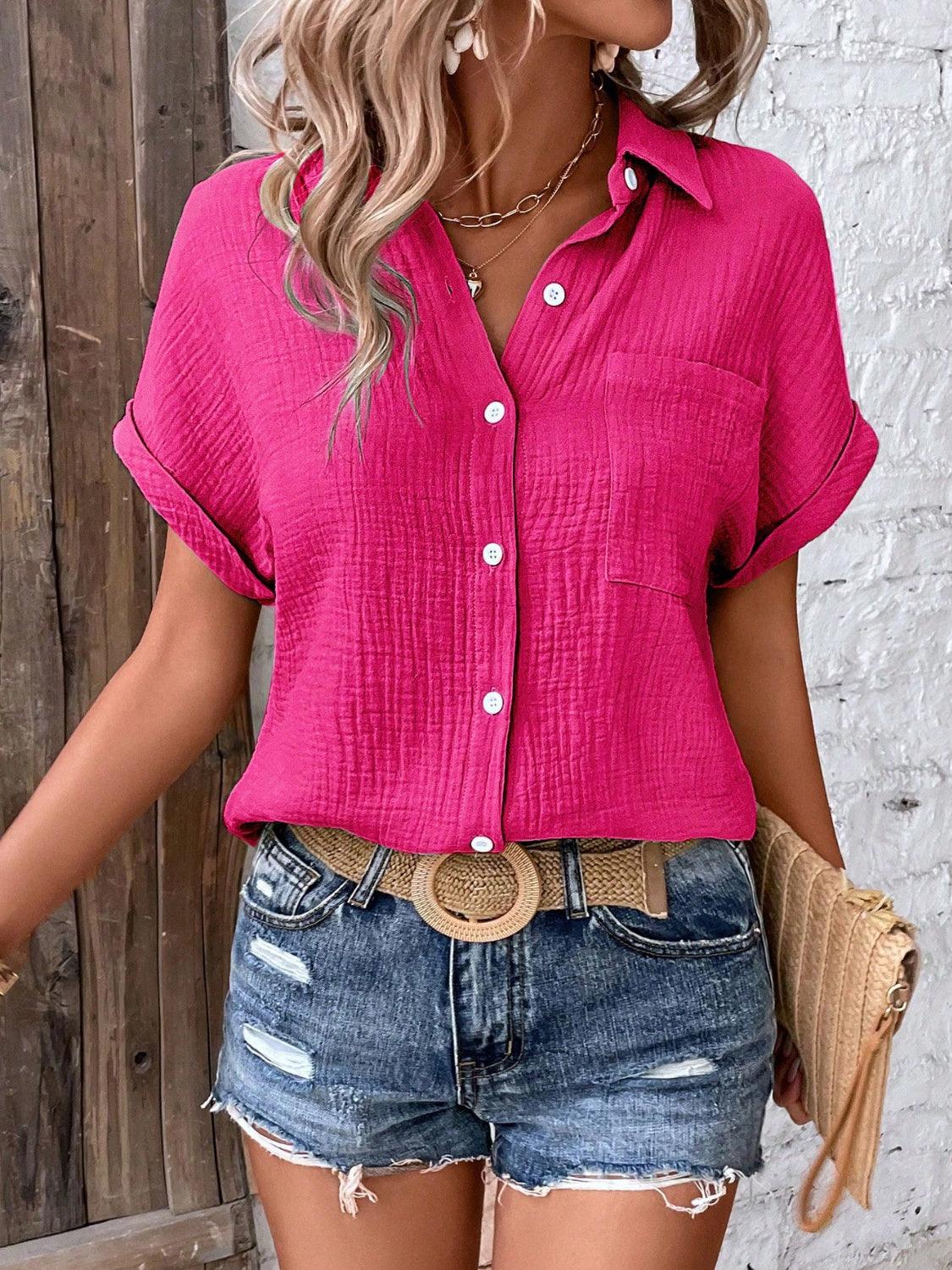 a woman wearing a pink shirt and denim shorts