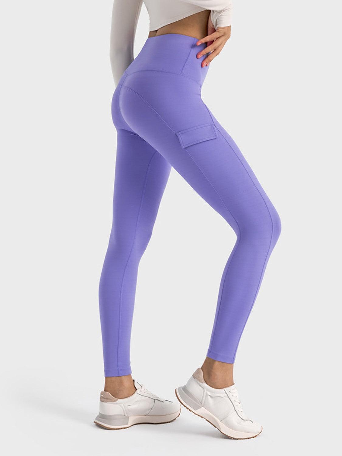 a woman in a white top and purple leggings