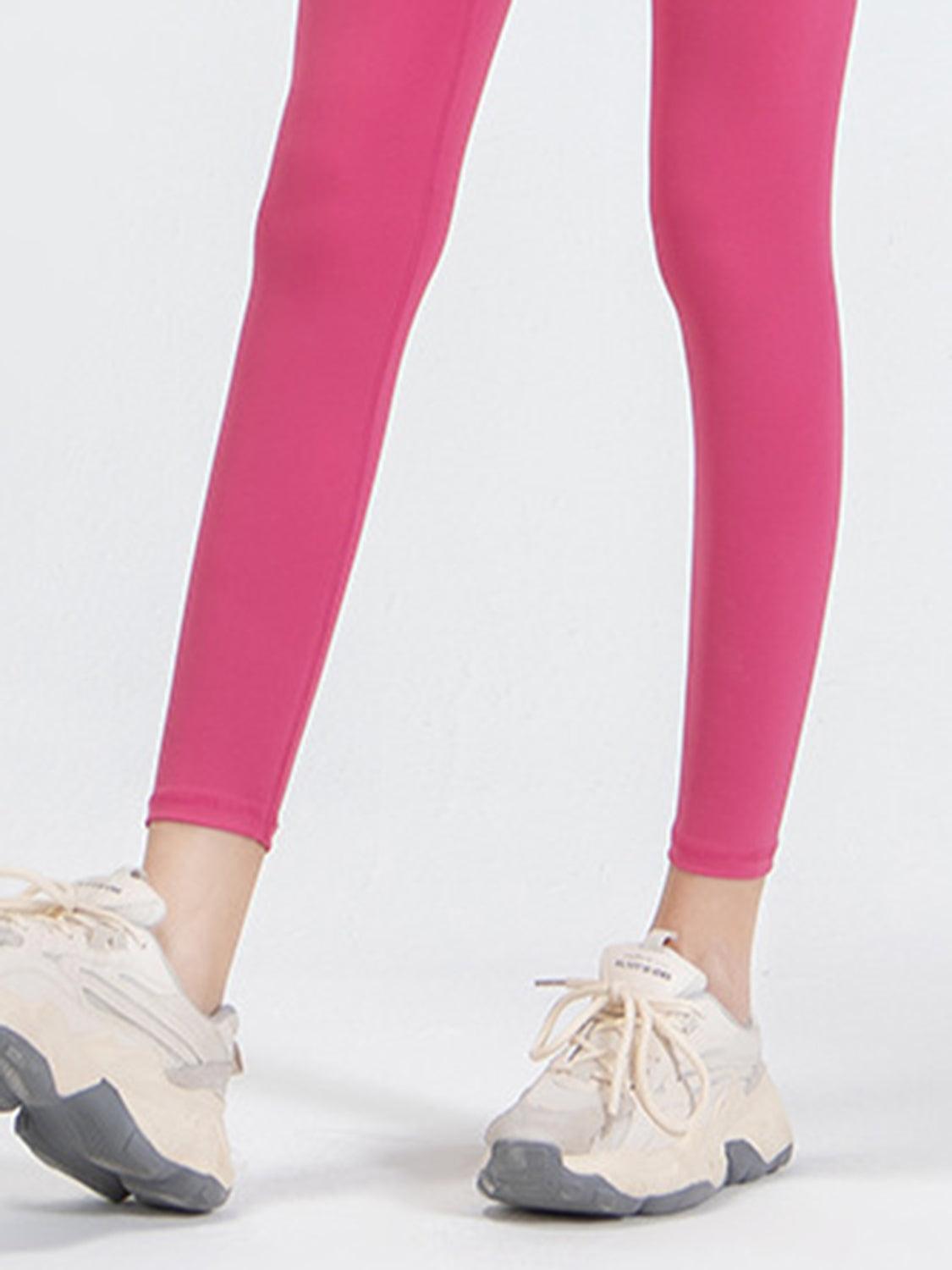 a woman in pink leggings and sneakers