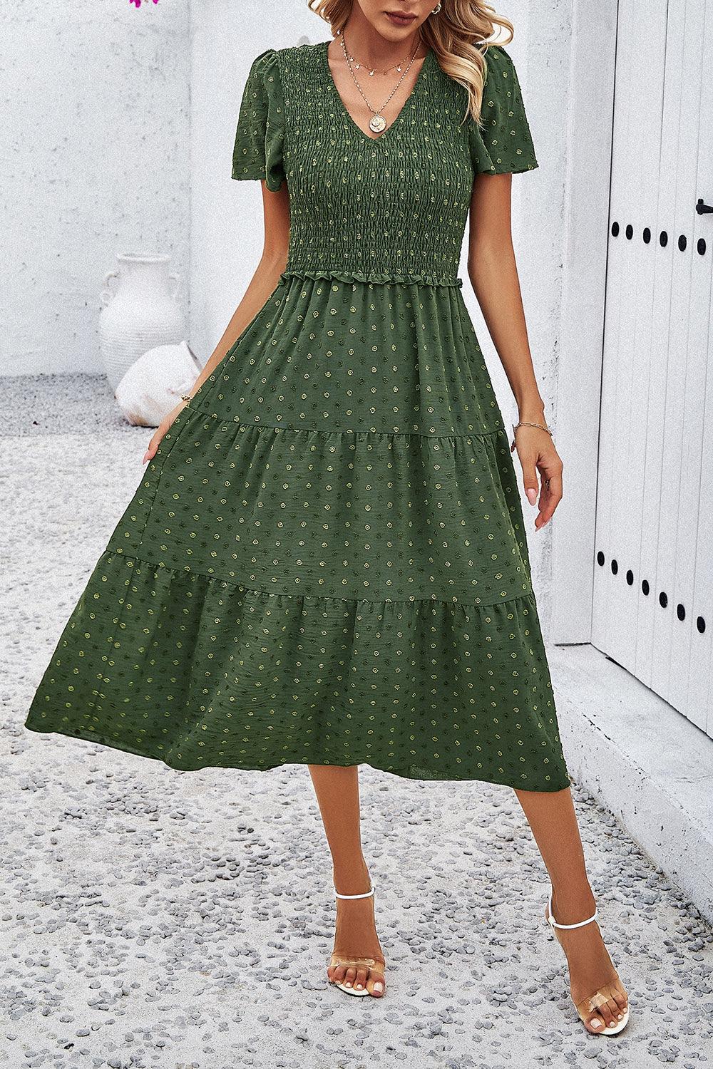 a woman wearing a green polka dot dress