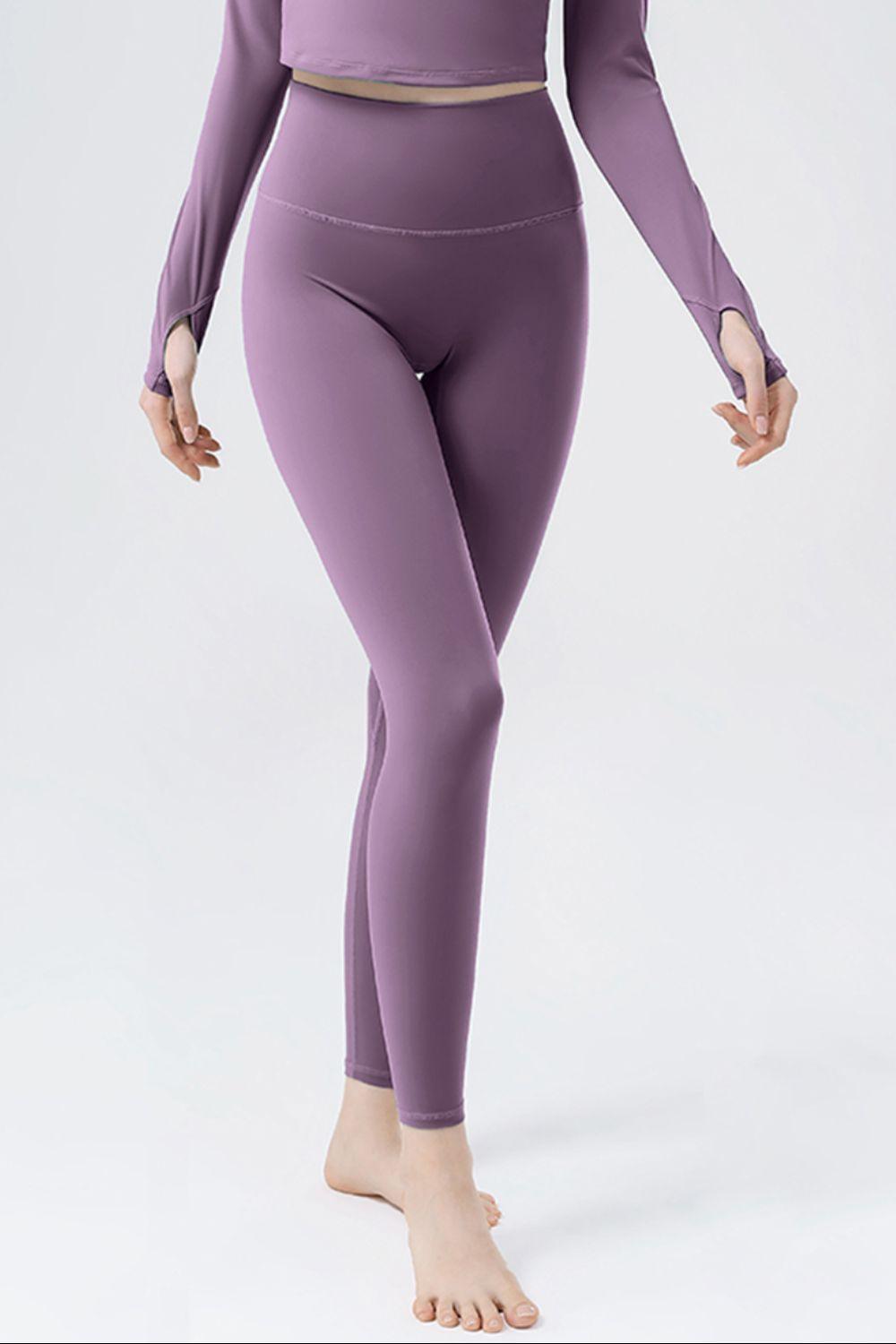 a woman in a purple top and leggings