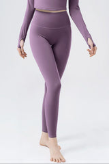 a woman in a purple top and leggings