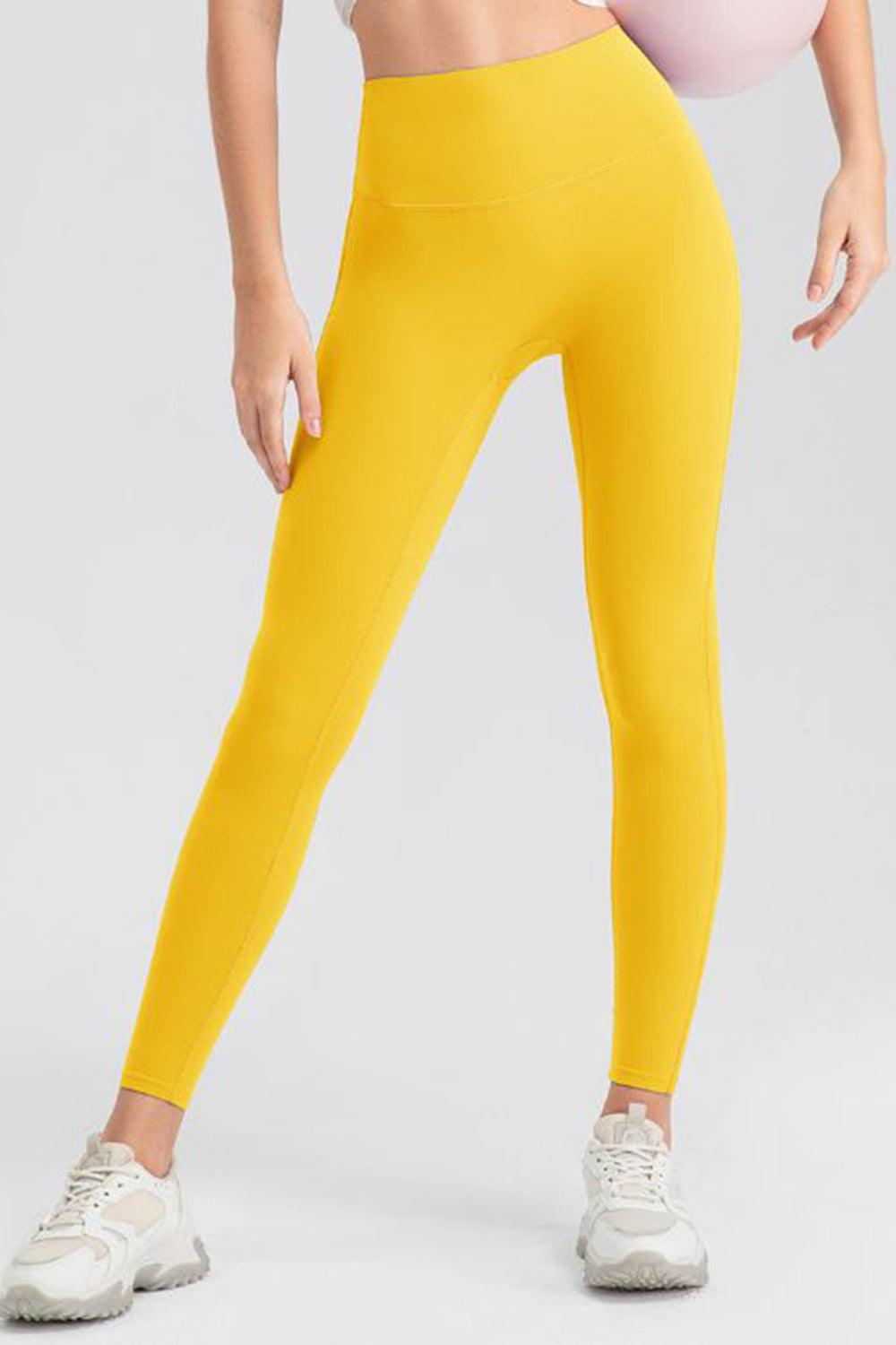 a woman in a white top and yellow leggings