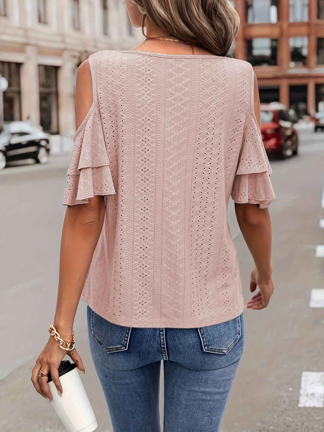 a woman walking down the street wearing a pink top